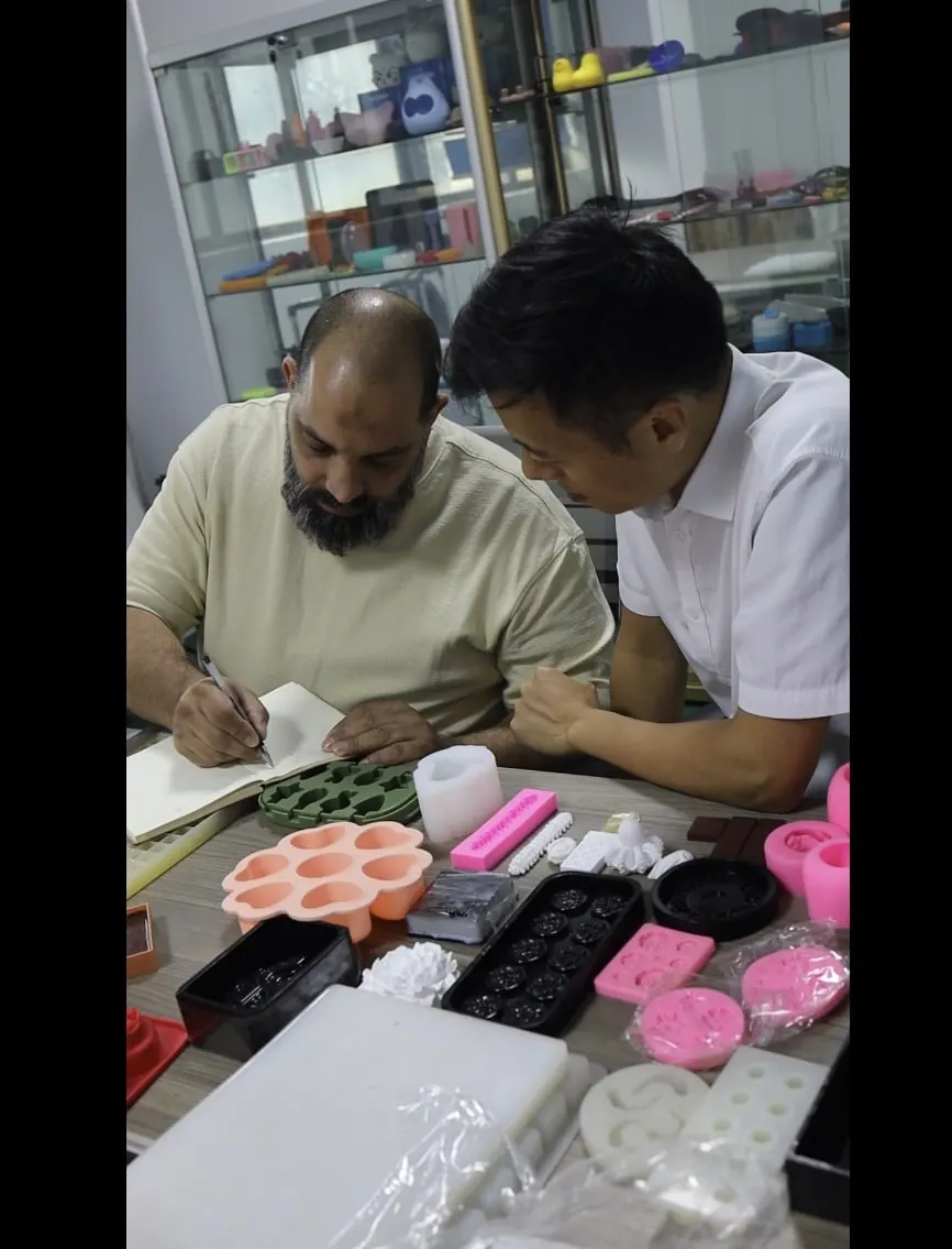 Buyer and WYD staff reviewing silicone mold samples at the plant