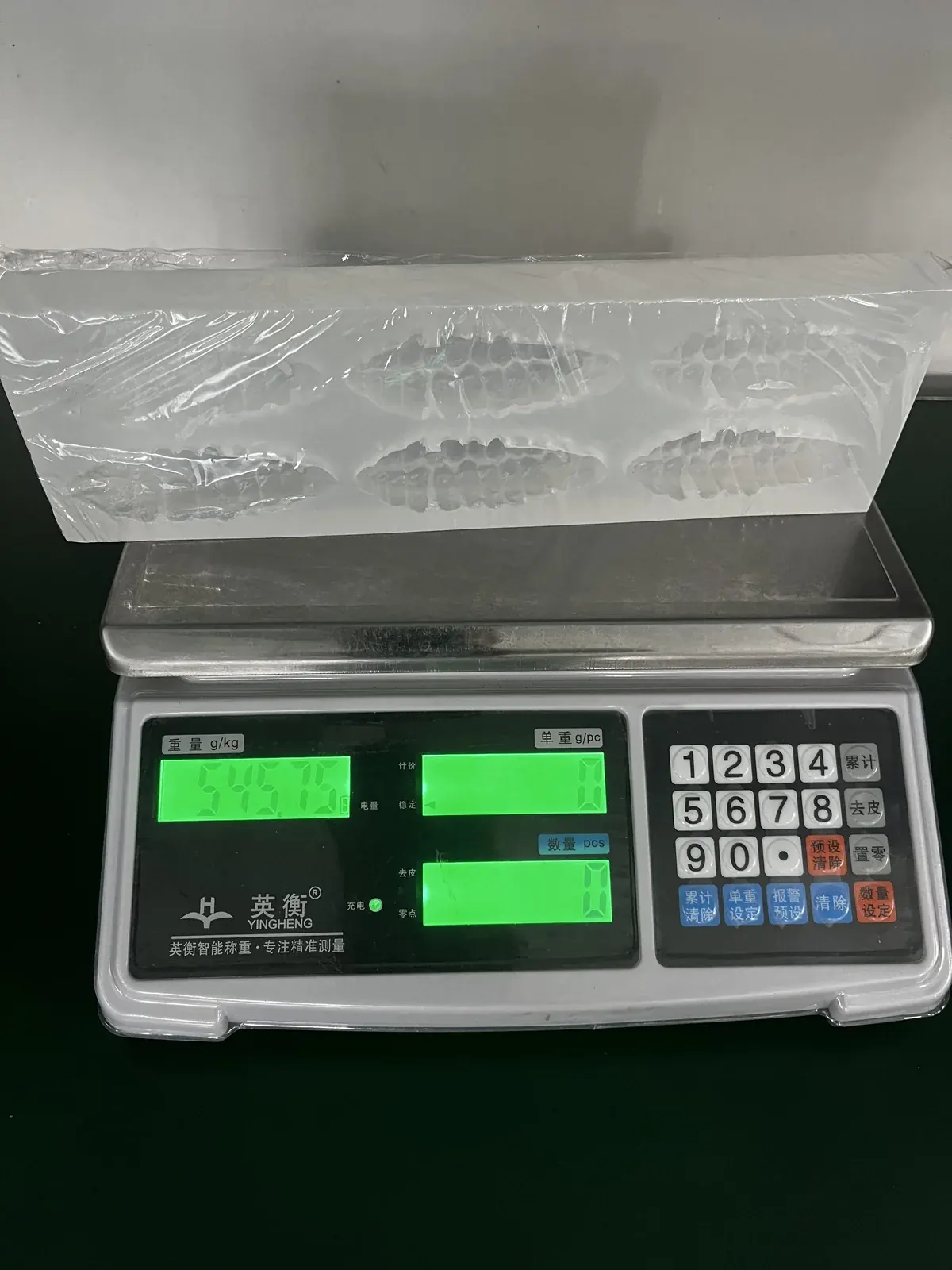 Custom cacao-fruit silicone trays on a scale during outbound weigh-out