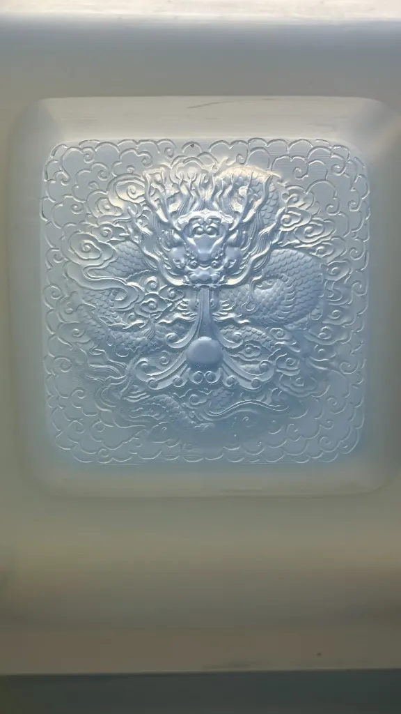 Translucent silicone mold with a coiled dragon relief and pearl