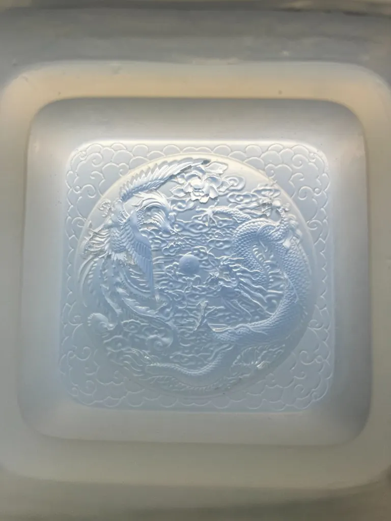 Silicone mold with dragon and phoenix relief in one square well