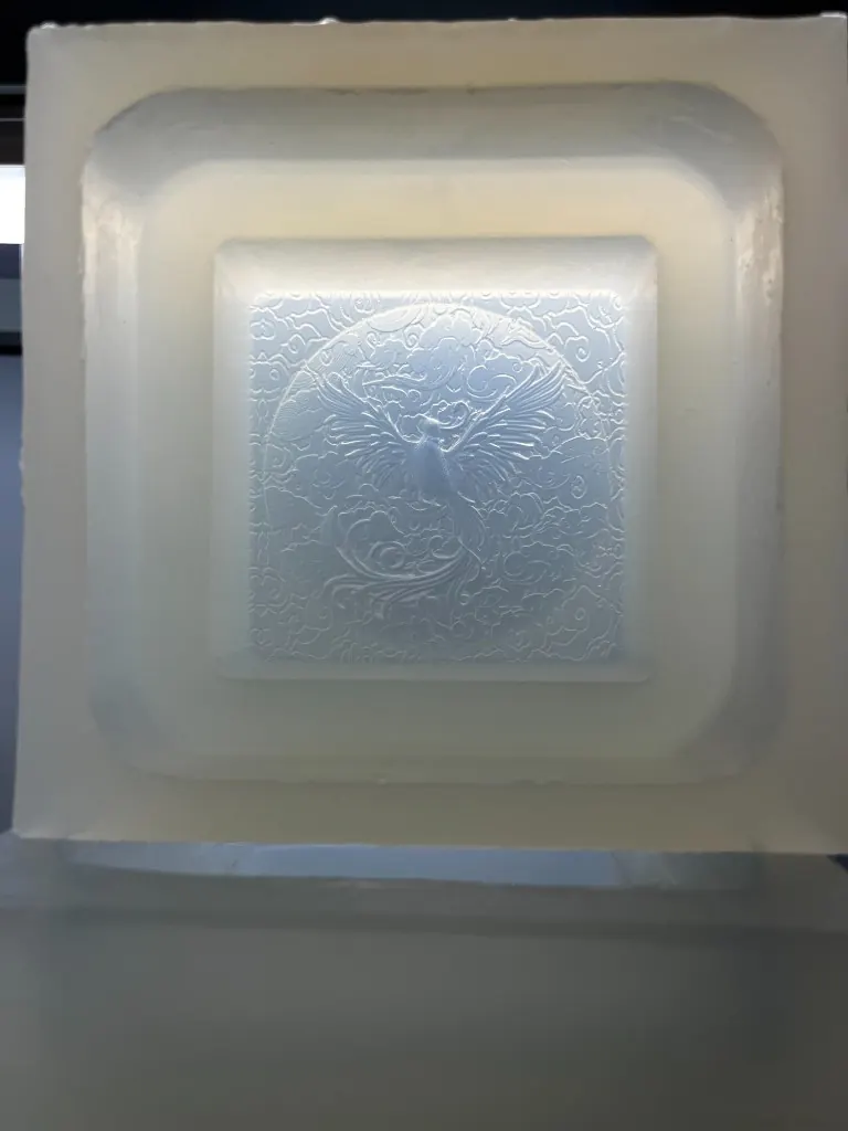 Silicone mold cavity of a phoenix in a circular cloud field