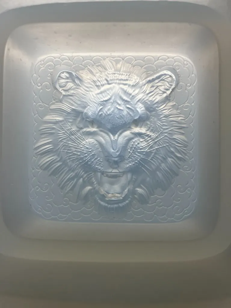 Silicone mold cavity of a tiger face with whisker and brow lines