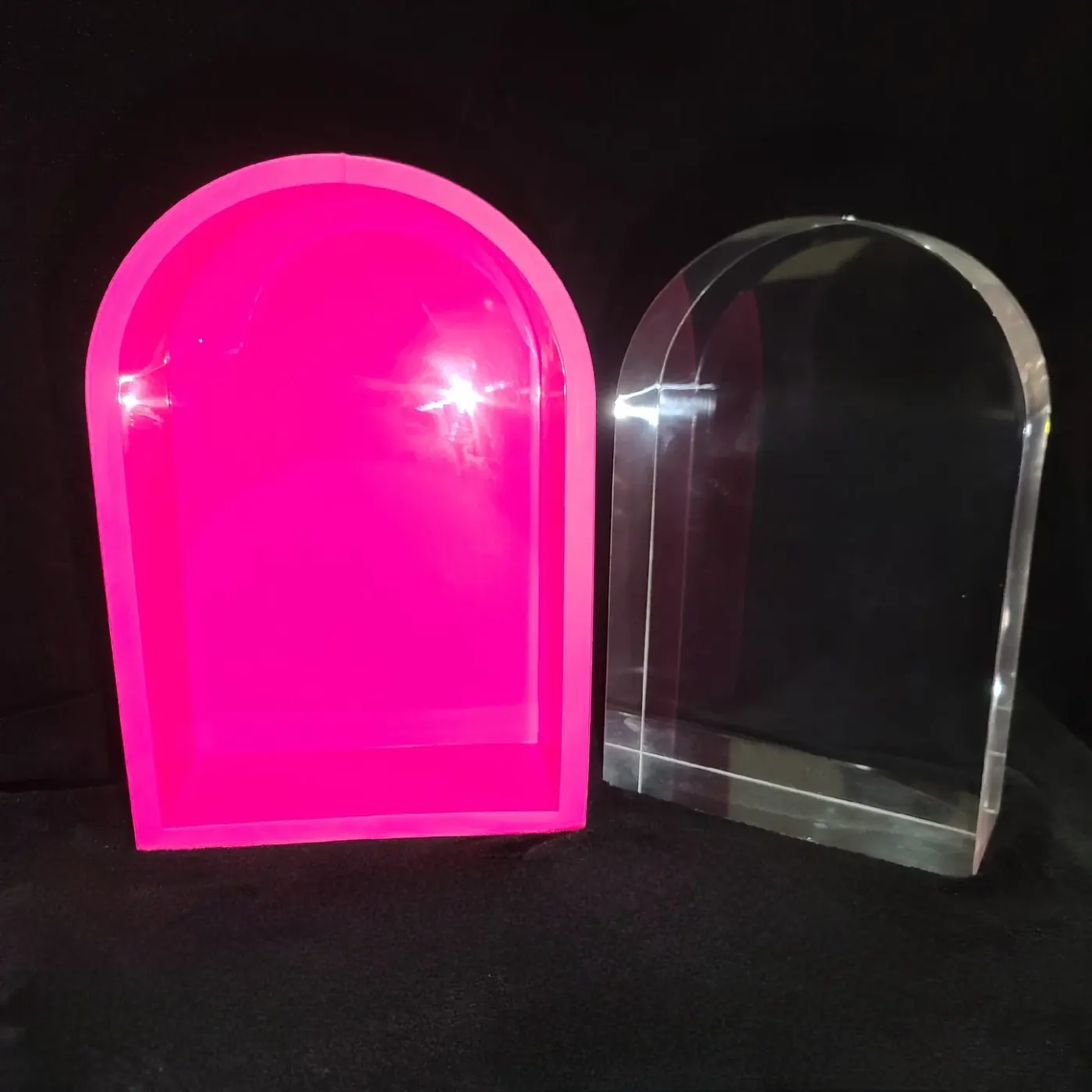 Pink RTV silicone arch mold beside a clear resin casting