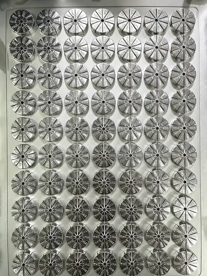 Grid of machined steel orange-slice gummy cavity inserts