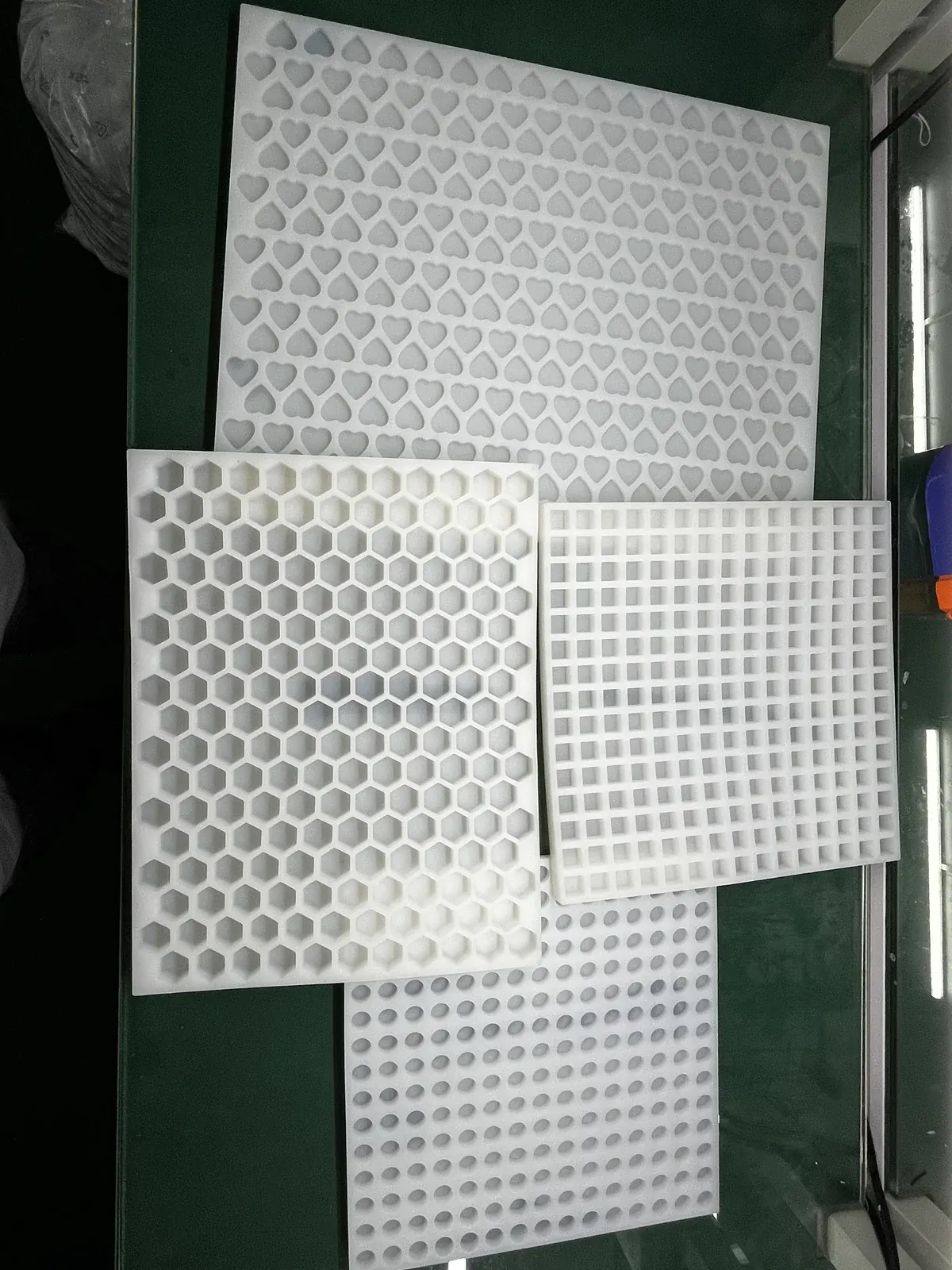 Multiple custom multi-cavity silicone gummy trays arranged together