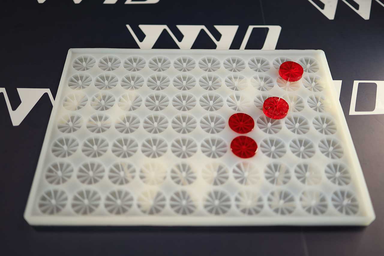 Multi-cavity silicone gummy tray on a WYD bench with a few poured pieces