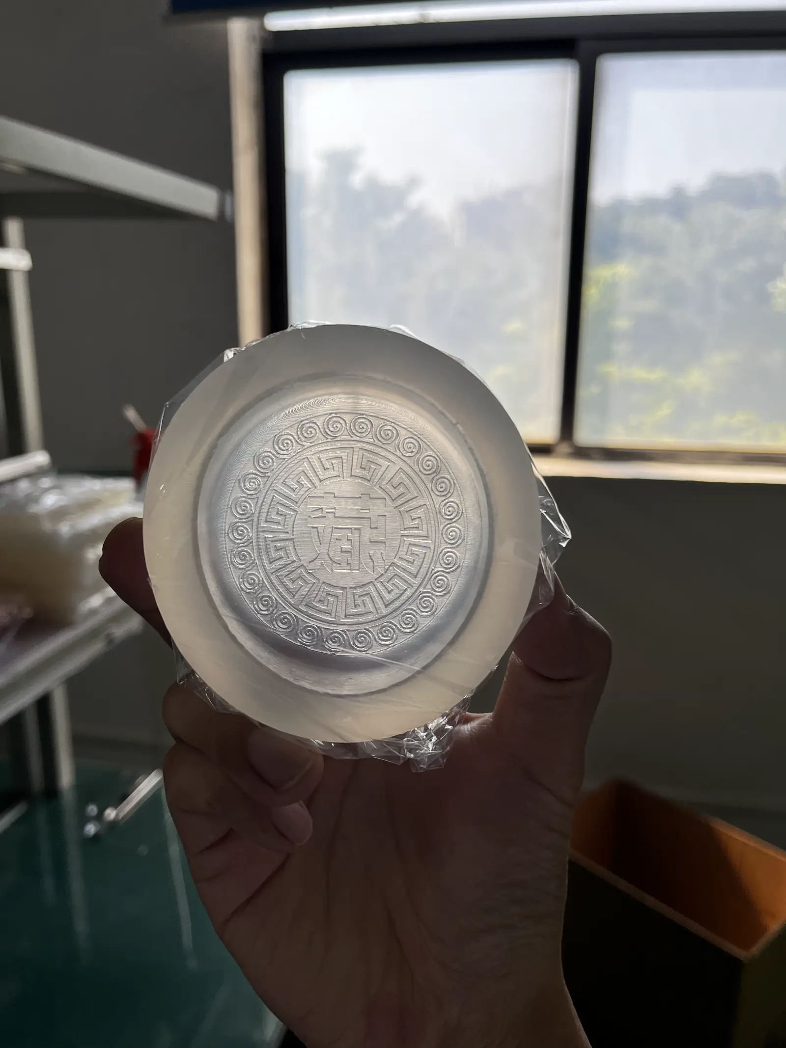 Round silicone mold with a center character and key-fret border